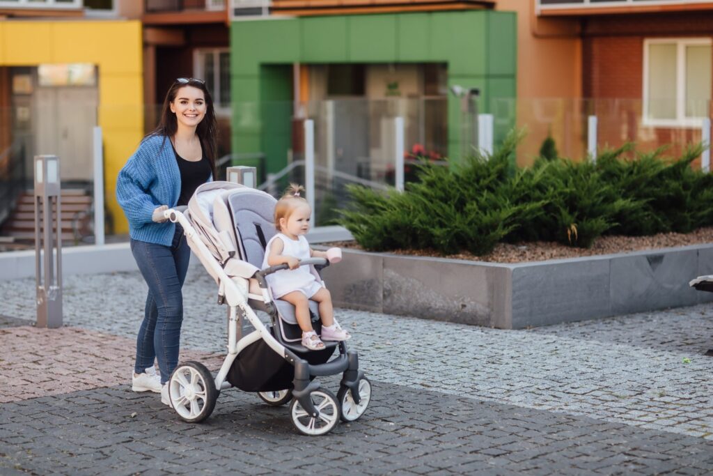 young-mother-walking-with-her-baby-carries-it-beautiful-pram-happiness-min