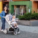 young-mother-walking-with-her-baby-carries-it-beautiful-pram-happiness-min